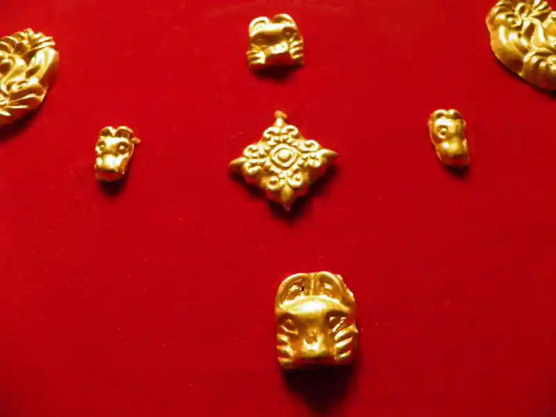 Gold jewelry cross with fleur-de-lis